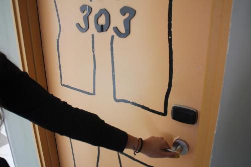 a person is drawing on a door with the number yet at Regantris Surabaya in Surabaya