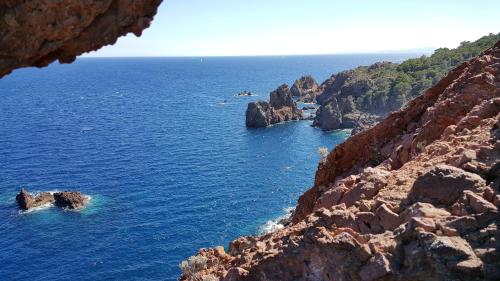 a view of the ocean from a cliff at Logis Hotel l'Esterella in Agay - Saint Raphael