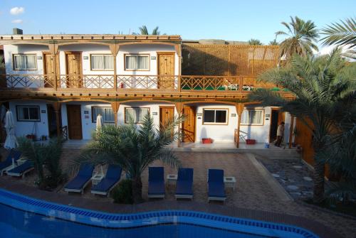a villa with a swimming pool and a house at Acacia Dahab Hotel in Dahab