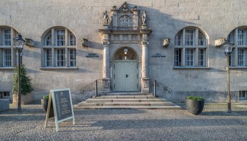 a door to a building with a sign in front at Hotel Oderberger in Berlin