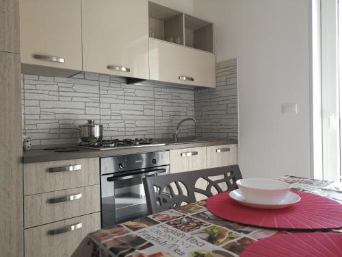 a kitchen with a table with a bowl on it at Manolo Case Vacanza in Monopoli