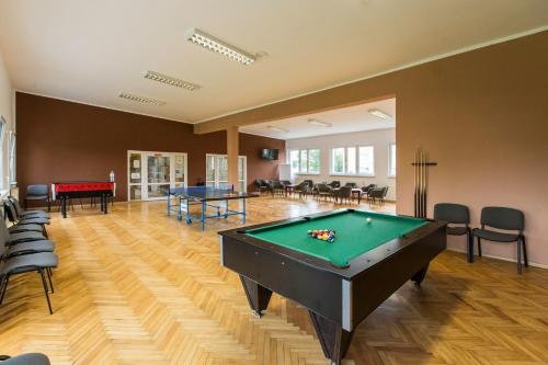 a large room with a pool table in it at OW Fala 1 in Łazy