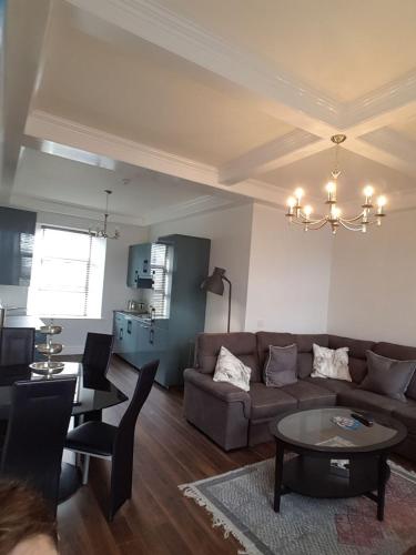 a living room with a couch and a table at Cill Aodain Court Hotel in Kiltimagh