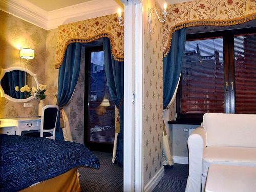 a bedroom with a bed and a desk and a window at SleepWalker Boutique Suites in Wrocław