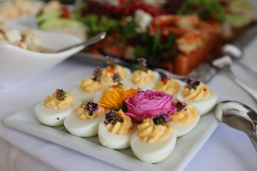 a plate of deviled eggs with a flower on it at Pension Villa Beer in Stralsund