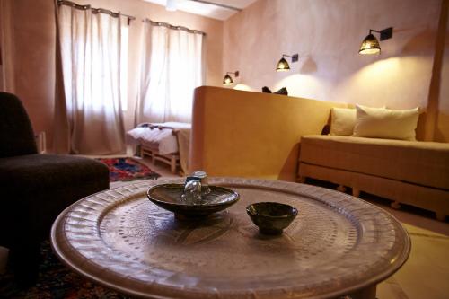 a bowl on a table in a living room at Riad Caravane in Aït Benhaddou