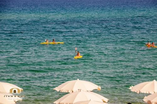 a group of people on kayaks in the water at Albergo Diffuso Mannois in Orosei