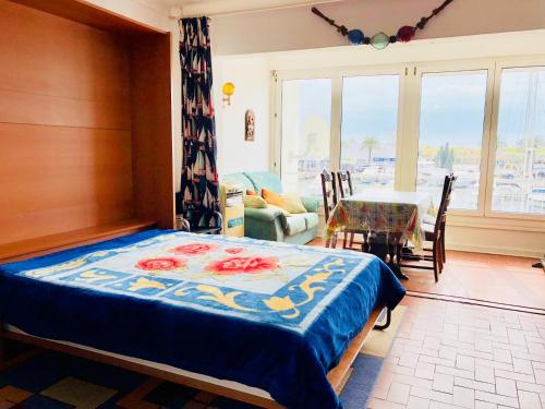 a bedroom with a bed and a dining room with a table at NAUTICA 2 E in Empuriabrava