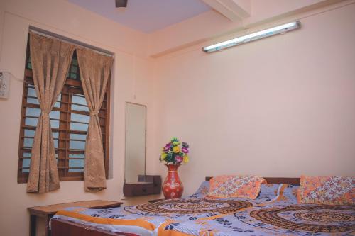 A bed or beds in a room at Prabhukrupa Tourist Farm