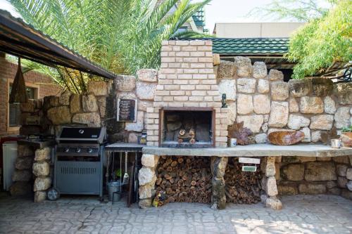 a stone kitchen with a stove and a stone wall at Villa Africa Guesthouse in Tsumeb