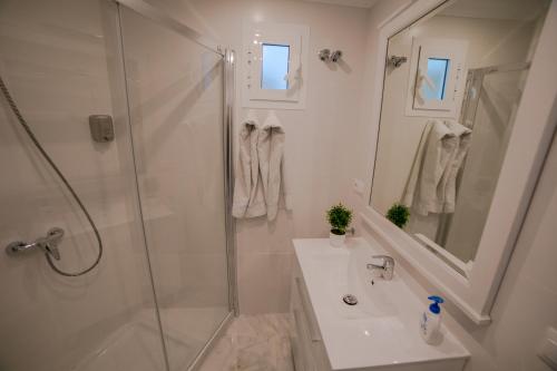 マラガにあるApartamento Itacaの白いバスルーム(シャワー、シンク付)