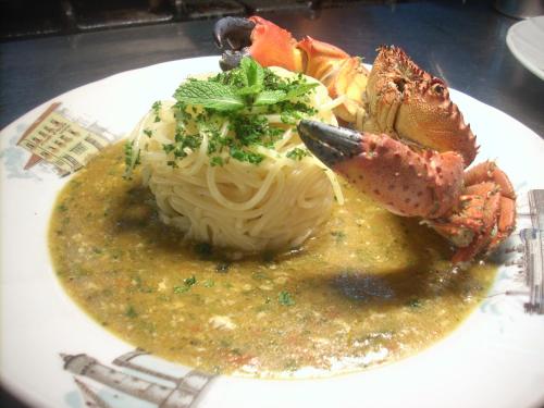 a plate of food with pasta and seafood in sauce at Ai Campi Di Marcello Hotel in Monfalcone