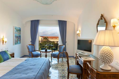 a hotel room with a bed and a television at Grand Hotel La Favorita in Sorrento