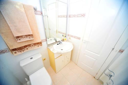 a bathroom with a toilet and a sink and a shower at Cala Gonzalez Superior Orange Costa in Alcossebre