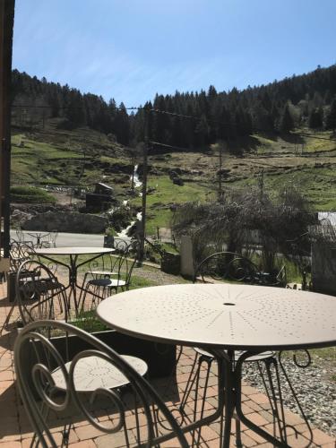 a group of tables and chairs sitting on a patio at Chez Jeanmyvonne in La Bresse