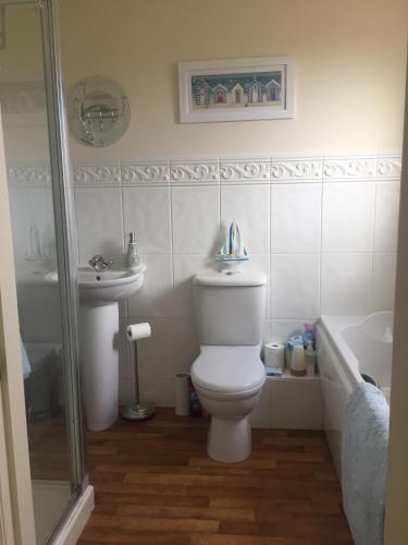 a bathroom with a toilet and a sink at Highbury House, Warm and Welcoming. in Darlington