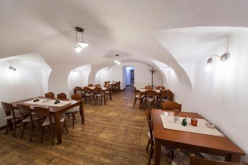 a restaurant with tables and chairs in a room at Penzion U Lucerny in Jindrichuv Hradec