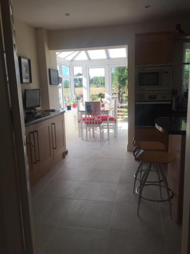a kitchen with a view of a dining room at Highbury House, Warm and Welcoming. in Darlington