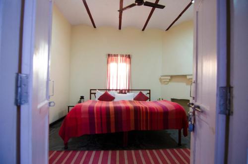 A bed or beds in a room at Naurang Yatri Niwas