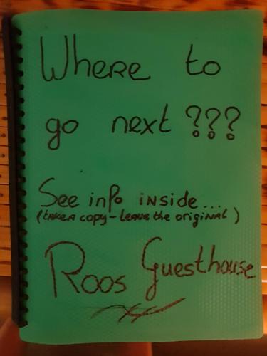 a book with writing on the cover of a notebook at Roos Guesthouse in Moalboal