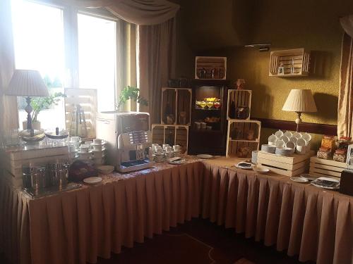 a table with a coffee maker on top of it at Hotel Batory in Tłuszcz