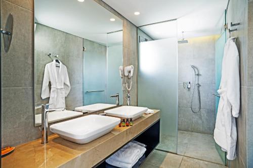 a bathroom with two sinks and a shower at Hotel Lozenge in Athens