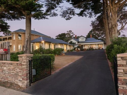 a large brick building with a tree on the side of it at Mt Martha Villas in Mount Martha