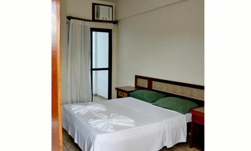 Un pat sau paturi într-o cameră la Pousada Enseada do Corsário