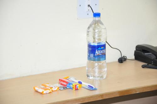 a bottle of water sitting on top of a desk at Hotel Chanma International in Coimbatore