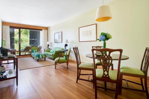 
a living room filled with furniture and a table at Quinta da Casa Branca in Funchal
