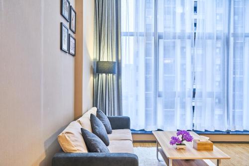 a living room with a couch and a coffee table at Plesant Daily Rental Apartment in Hangzhou