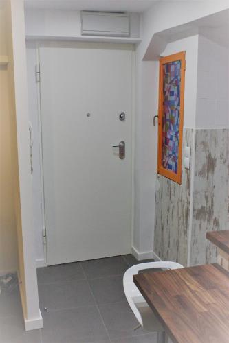 a white door in a room with a table at Vive Vitoria en la Almendra Medieval P9 in Vitoria-Gasteiz
