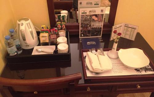 a table with a counter top with a sink and a table sidx sidx at Massabki Hotel in Chtaura