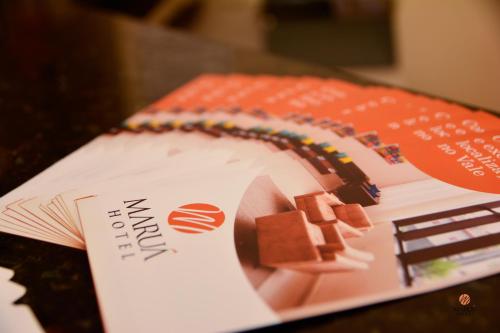 a book sitting on top of a table at Hotel Maruá in São José dos Campos