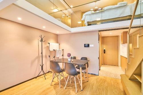 a dining room with a table and chairs and a bunk bed at Plesant Daily Rental Apartment in Hangzhou