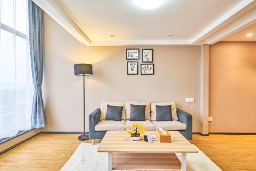 a living room with a couch and a table at Plesant Daily Rental Apartment in Hangzhou
