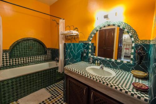 a bathroom with a sink and a mirror at Riad Lalla Zoubida in Fès