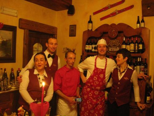 a group of people posing for a picture in a bar at Hotel Mignon in Breuil-Cervinia