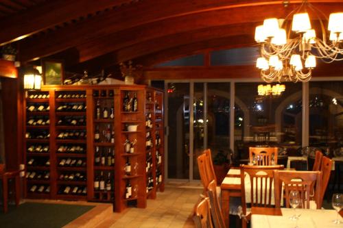 a dining room with a table and a bunch of wine bottles at Luxury Sea Residence by Kristina in Tivat