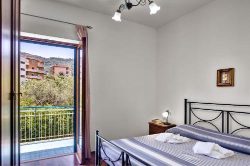 a bedroom with a bed and a view of a balcony at Caruso 4 in Sorrento