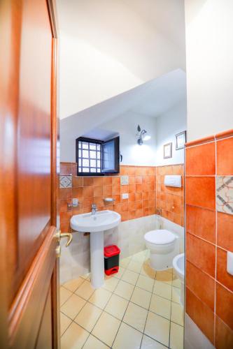 a bathroom with a sink and a toilet at Casa Marta in Cefalù