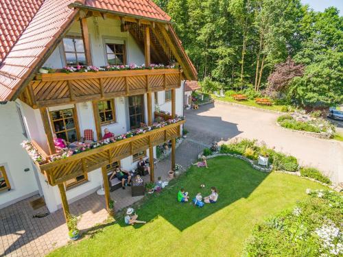an overhead view of a house with people sitting on the lawn at Eulenberghof Kraus in Altenkunstadt