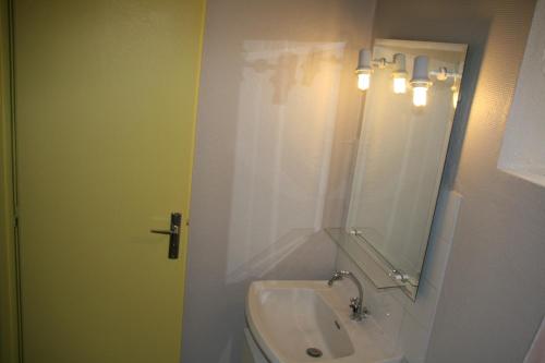 een badkamer met een wastafel en een spiegel bij Village Camping Les Vignes in Puy-lʼÉvêque