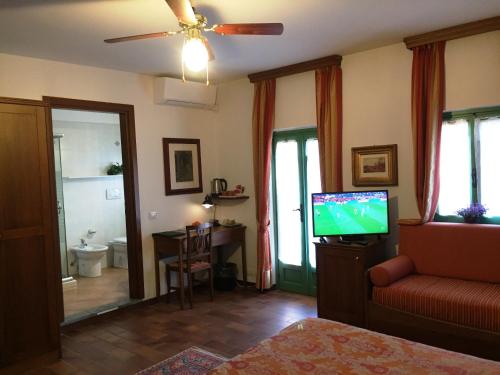 a living room with a tv and a couch and a table at Casa Violetta B&B in Agrate Conturbia