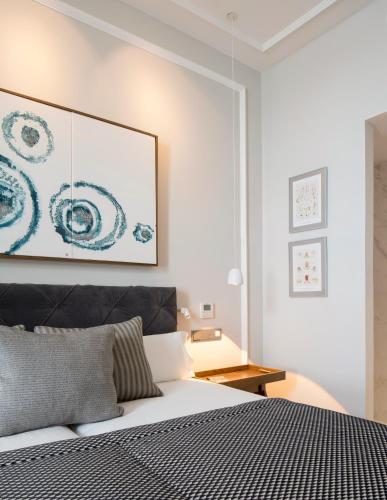 a bedroom with a bed and a picture on the wall at Lasala Plaza Hotel - Adults Only in Donostia-San Sebastián