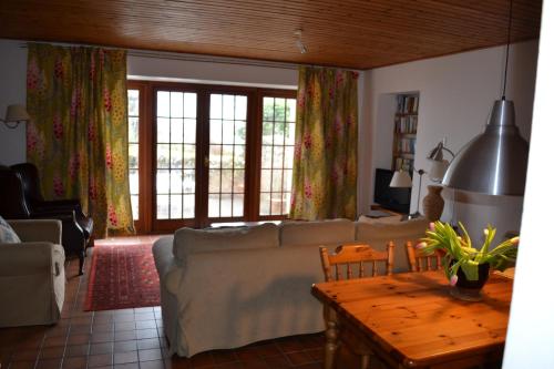 a living room with a couch and a table at Oban Seil Farm in Clachan