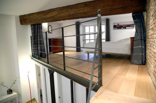 a loft bed in a room with a bedroom at Atout Carmes in Toulouse