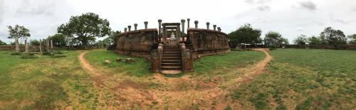 a large wooden building sitting in a field at Araliya OceanFront Condos Nilaveli, Trincomalee in Nilaveli
