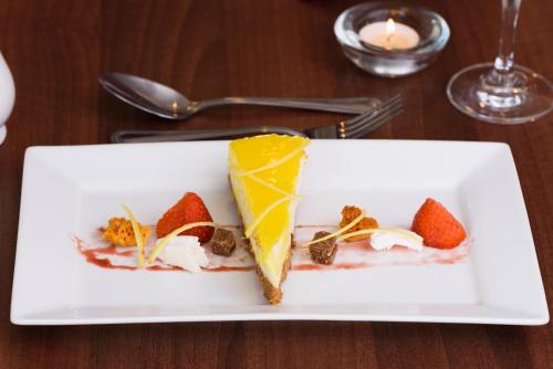 a white plate with a dessert on a table at The Crown Hotel in Newton Stewart