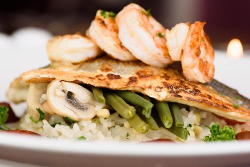 a plate of food with fish and rice and mushrooms at The Crown Hotel in Newton Stewart